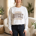 Woman wearing the white Leopard Luxe Expensive and Difficult sweatshirt